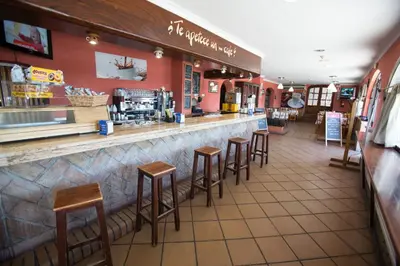 a bar in a restaurant with stools at Hotel Quitagolpe in Jerez de la Frontera