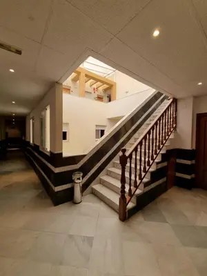a hallway with a staircase in a building at Hotel Quitagolpe in Jerez de la Frontera