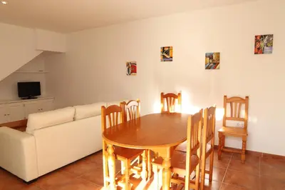 a living room with a table and a couch at Apto en Residencial El Bosque in Chiclana de la Frontera