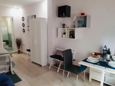 a living room with a table and a dining room at La Joya de la Caleta. A 60 mts playa. in Cádiz