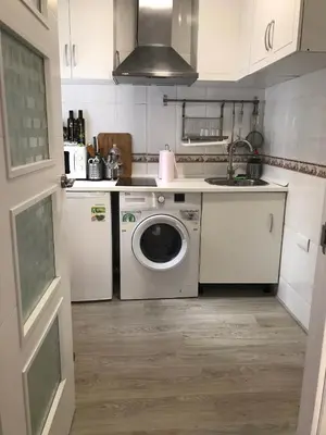 a kitchen with a washing machine and a sink at La Joya de la Caleta. A 60 mts playa. in Cádiz