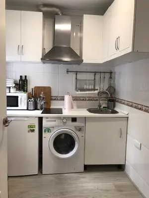 a kitchen with a washing machine and a sink at La Joya de la Caleta. A 60 mts playa. in Cádiz