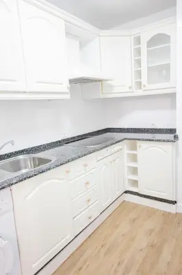 a white kitchen with white cabinets and a sink at Pisoelpuerto in El Puerto de Santa María
