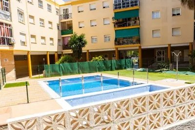 a swimming pool in front of a building at Pisoelpuerto in El Puerto de Santa María