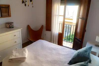 a bedroom with a bed and a large window at Light House Sherry in Jerez de la Frontera