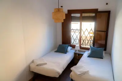 two twin beds in a room with a window at Light House Sherry in Jerez de la Frontera