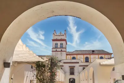 a view of a building with a clock tower at Hotel Palacio Marqués de Arizón in Sanlúcar de Barrameda