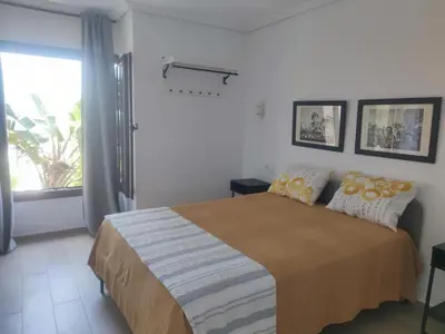 a bedroom with a large bed and a window at Luz de la Bahía San Fernando Cádiz in San Fernando