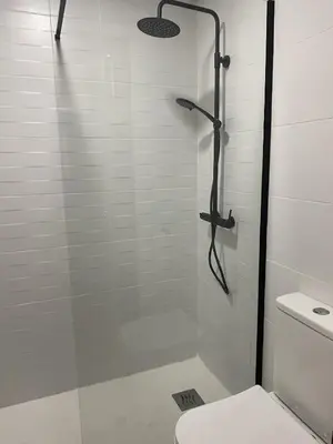 a shower with a glass door next to a toilet at Luz de la Bahía San Fernando Cádiz in San Fernando