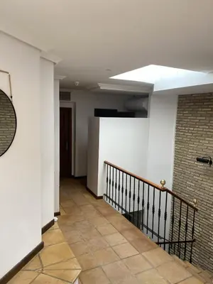 a hallway with a staircase and a brick wall at Luz de la Bahía San Fernando Cádiz in San Fernando