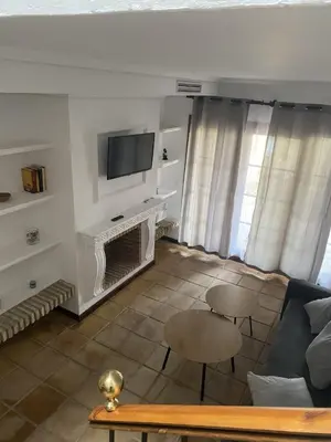 a living room with a couch and a tv at Luz de la Bahía San Fernando Cádiz in San Fernando