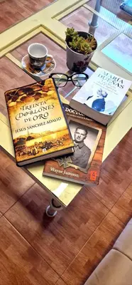 a table with three books on top of a table at Reina Mercedes in Chipiona