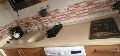 a kitchen counter with a sink and a dishwasher at Reina Mercedes in Chipiona