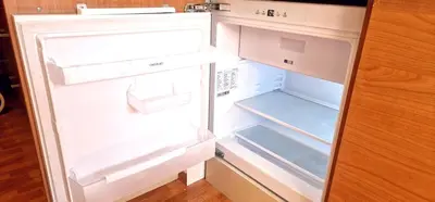 an empty refrigerator with its door open with its door open at Reina Mercedes in Chipiona