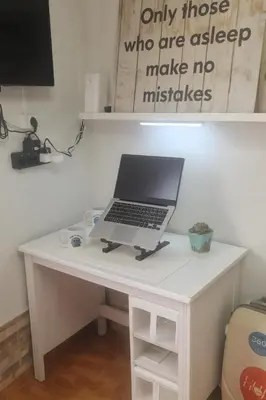 a laptop computer sitting on a white desk at Reina Mercedes in Chipiona
