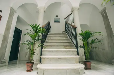 a staircase in a building with two plants at Apartamentos casa palacio in El Puerto de Santa María