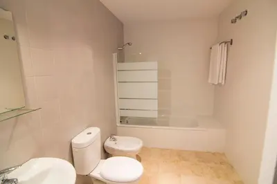 a bathroom with a toilet and a sink and a tub at apartamento plaza san juan in El Puerto de Santa María