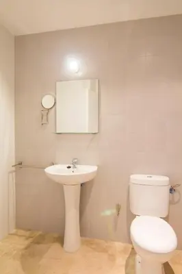 a bathroom with a white toilet and a sink at apartamento plaza san juan in El Puerto de Santa María