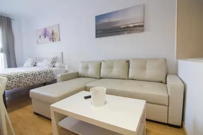 a living room with a couch and a table at apartamento plaza san juan in El Puerto de Santa María