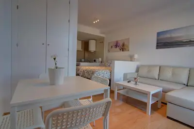 a living room with a table and a couch at apartamento plaza san juan in El Puerto de Santa María