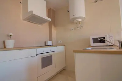 a kitchen with a sink and a microwave at apartamento plaza san juan in El Puerto de Santa María