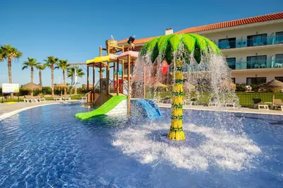 a pool with a water park with a water slide at Hotel Best Costa Ballena in Costa Ballena