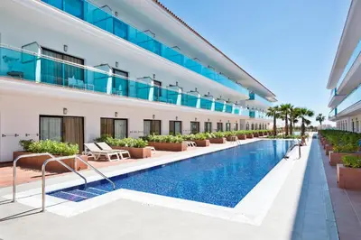 an external view of a building with a swimming pool at Hotel Best Costa Ballena in Costa Ballena