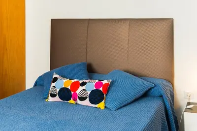 a bed with two pillows on top of it at Coqueto estudio in Cádiz