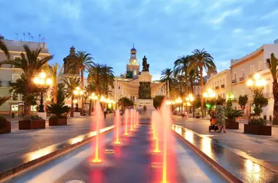 a city street with lights and a clock tower at Coqueto estudio in Cádiz