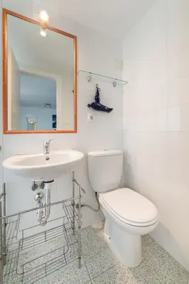 a bathroom with a toilet and a sink and a mirror at Coqueto estudio in Cádiz