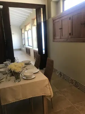 a dining room with a table with plates and flowers on it at Villa Chill In in Chiclana de la Frontera