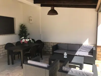 a living room with a couch and a table at Villa Chill In in Chiclana de la Frontera