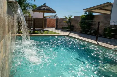 a swimming pool with a water fountain at Villa Nueva Cascada - Casa Rustica 