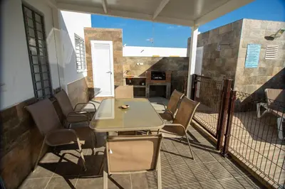 a patio with a table and chairs on a balcony at Villa Nueva Cascada - Casa Rustica 