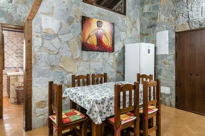 a dining room with a table and a stone wall at Villa Nueva Cascada - Casa Rustica 