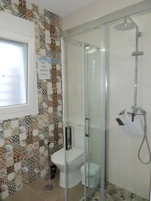 a bathroom with a toilet and a glass shower at Villa Nueva Cascada - Casa Rustica 