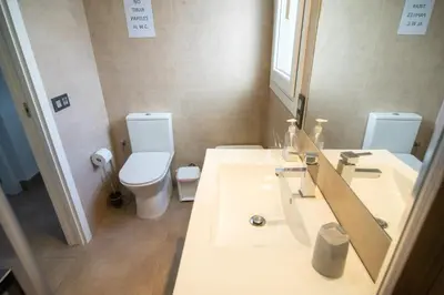 a bathroom with a sink and a toilet and a mirror at Villa Nueva Cascada - Casa Rustica 