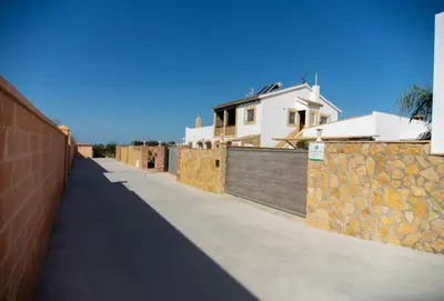 a sidewalk in front of a house with a fence at Villa Nueva Cascada - Casa Rustica 