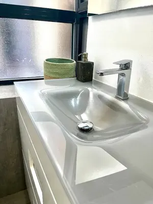 a white sink in a bathroom with a window at Lofts Miriam in Cádiz