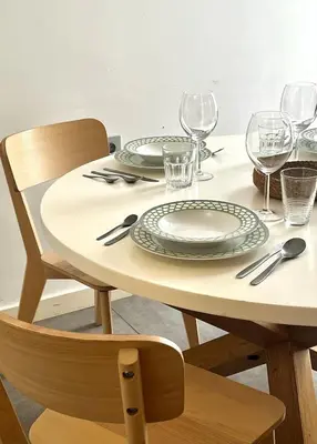 a table with two plates and glasses on it at Lofts Miriam in Cádiz