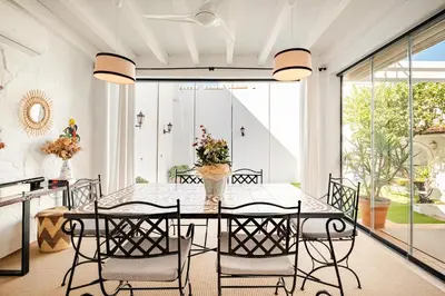 a dining room with a table and chairs at Casa palacio reformada S.XVIII in Sanlúcar de Barrameda