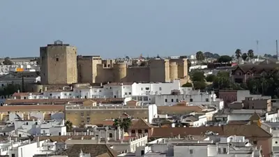 a view of a city with a castle at La Pandorga in Sanlúcar de Barrameda
