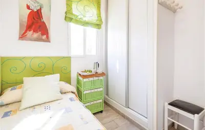 a small bedroom with a bed and a window at Nice Home In Arcos De La Frontera in Arcos de la Frontera