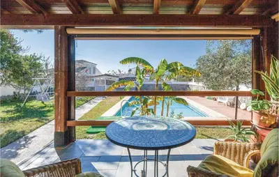 a patio with a table and a view of a pool at Nice Home In Arcos De La Frontera in Arcos de la Frontera