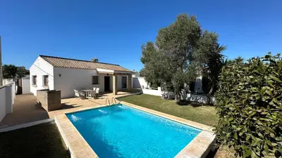 a swimming pool in the yard of a house at Vivienda Rural Atlántico Sur & Familias in Conil de la Frontera
