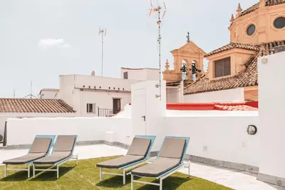 a bedroom with a large bed in a room at ASTUTO 21 Suites - Adults Only in Jerez de la Frontera
