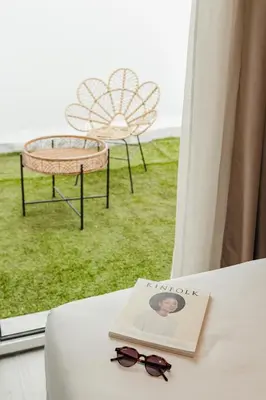two chairs sitting on the grass in front of a building at ASTUTO 21 Suites - Adults Only in Jerez de la Frontera