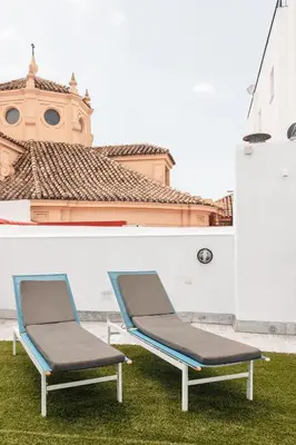 a living room with a couch and a dresser at ASTUTO 21 Suites - Adults Only in Jerez de la Frontera