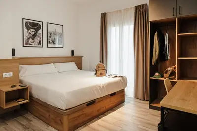 a bedroom with a large bed in a room at ASTUTO 21 Suites - Adults Only in Jerez de la Frontera