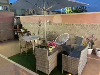 a table and chairs with an umbrella on a patio at Palast Stieg Guest House in Jerez de la Frontera